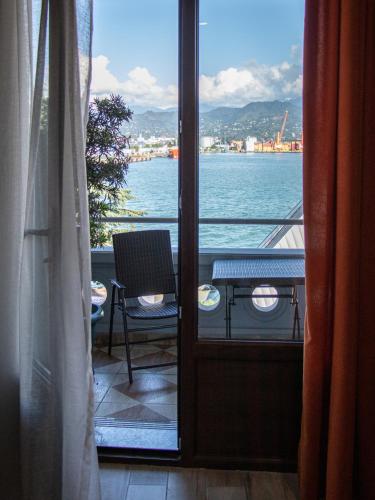 a room with a view of the water from a balcony at Boutique Hotel 32 in Batumi