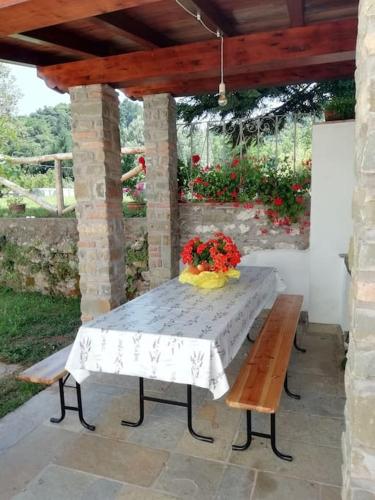 a picnic table with a vase of flowers on it at Ai tre Campi in Fornaci di Barga