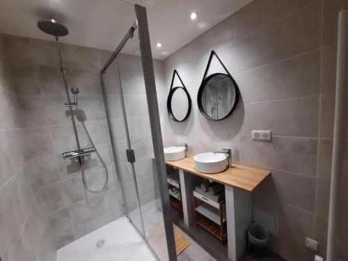 y baño con ducha, 2 lavabos y espejo. en La Loggia superbe appartement, en Pierry