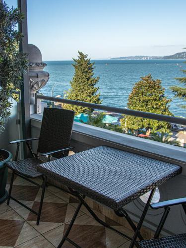a table and chairs on a balcony with a view of the ocean at Boutique Hotel 32 in Batumi