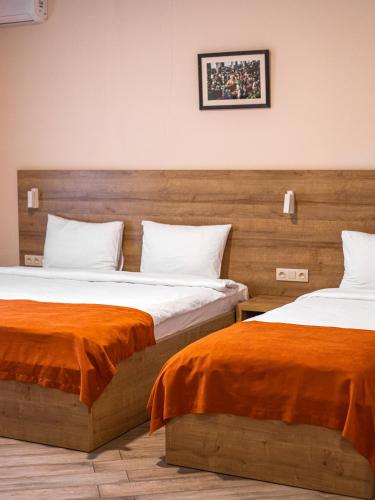two beds sitting next to each other in a room at Boutique Hotel 32 in Batumi