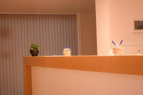 a counter top with a mirror and two jars of food at Hotel Nande in Nieves