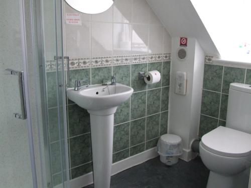 a bathroom with a sink and a toilet at Lichfield House in Weymouth