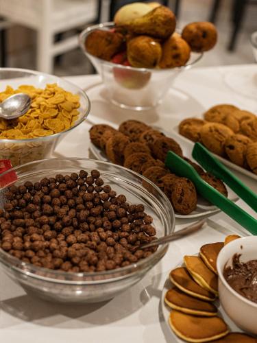 a table topped with bowls of nuts and cookies at Boutique Hotel 32 in Batumi