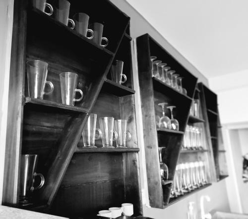 a shelf with cups and other items on it at Chill House make a Good Story with infinite Ocean Surf and Stay in Weligama