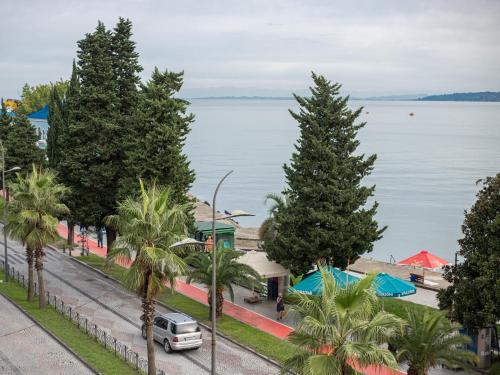a view of a street with trees and the water at Boutique Hotel 32 in Batumi