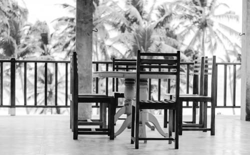 a group of chairs sitting in front of a table at Chill House make a Good Story with infinite Ocean Surf and Stay in Weligama