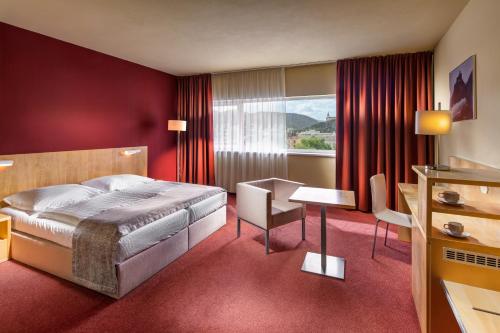 a hotel room with a bed and a desk at Clarion Congress Hotel Ústí nad Labem in Ústí nad Labem