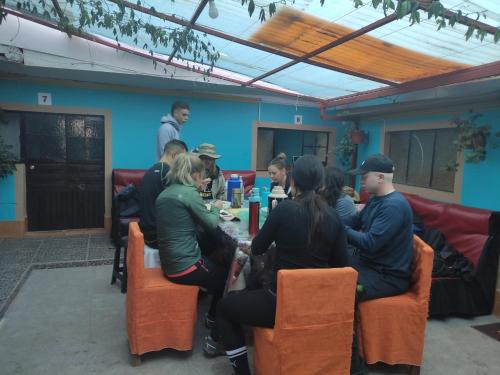 a group of people sitting around a table in a room at Hospedaje Munaycha in Checacupe