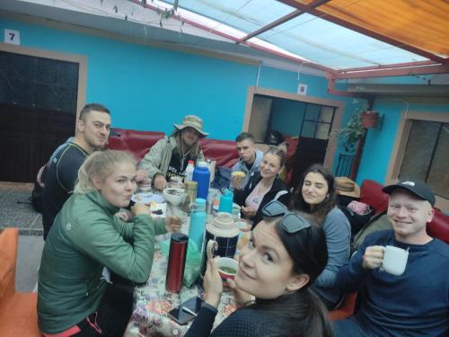 a group of people sitting around a table at Hospedaje Munaycha in Checacupe
