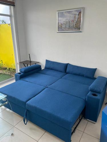 a blue couch in a room with a window at Casa Diamante Azul in Manzanillo