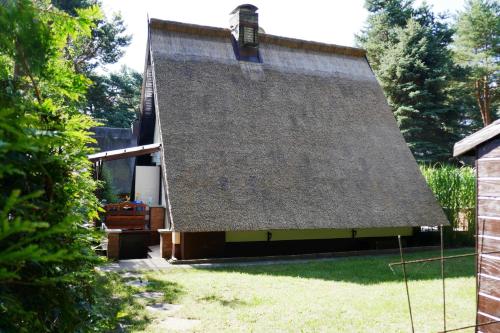 a house with a thatched roof and a yard at Reetdachhaus in Quilitz auf Usedom in Quilitz