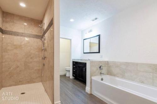 a bathroom with a white tub and a toilet at Bountiful Heights in Bountiful