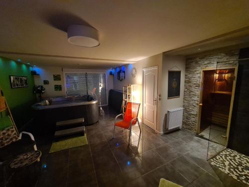 a living room with a sink and a table at Le Cocon - Gite Spa et Sauna privatif en Centre Alsace in Saint-Maurice