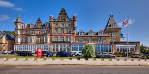 a large building with cars parked in front of it at Muthu Alexandra Hotel in Oban