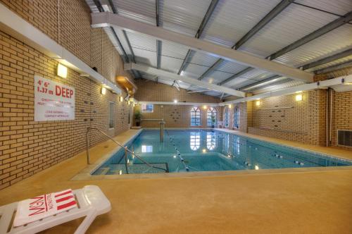 a large indoor swimming pool in a building at Muthu Alexandra Hotel in Oban