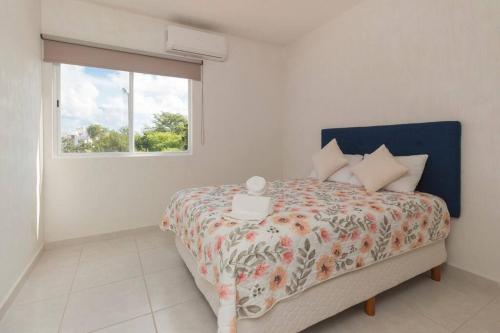 a bedroom with a large bed with a window at Casa Bella in Playa del Carmen