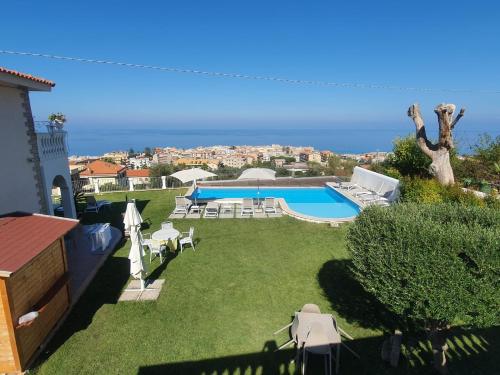 a backyard with a swimming pool and lawnitures at Appartamenti Borgo Panoramico N 5 in Tropea