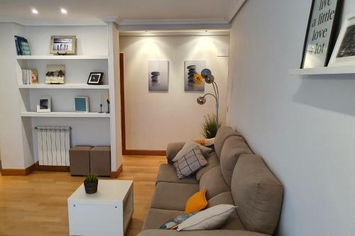 a living room with a couch and a table at Ondartxo - ONGI ETORRI in Zumaia