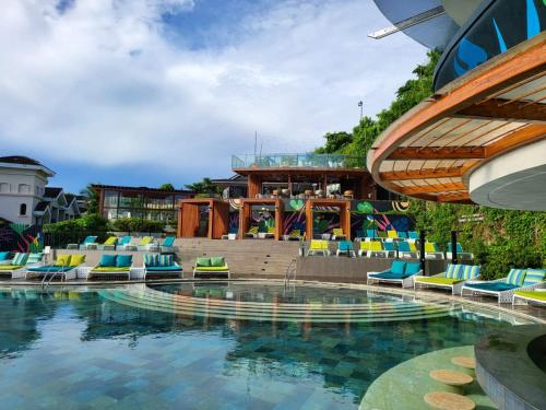 a pool at a resort with chairs and a bar at Fairways and Bluewater Boracay in Boracay