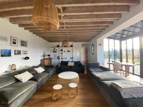 a living room with a couch and a table at L’Etable in Trouville-sur-Mer