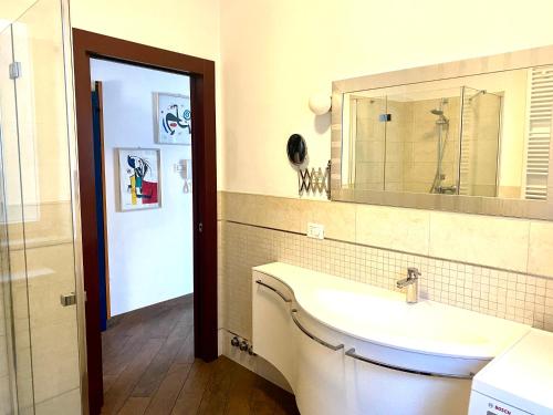 a bathroom with a sink and a mirror at APPARTAMENTO ELISA in Levico Terme