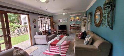 a living room with a couch and a coffee table at 3 Lagoon Getaways in Southbroom