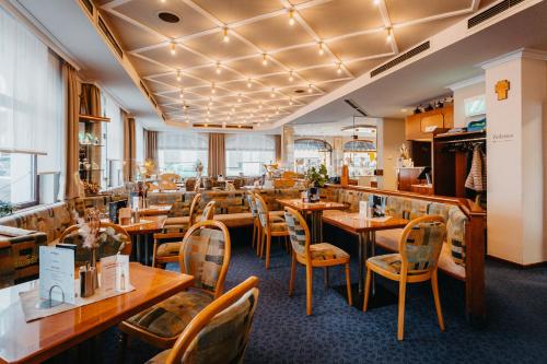 a restaurant with wooden tables and chairs at Hotel garni Fuchs in Eichstätt