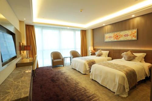 Un pat sau paturi într-o cameră la Shenzhen Baoan PLUS Gems Cube Hotel