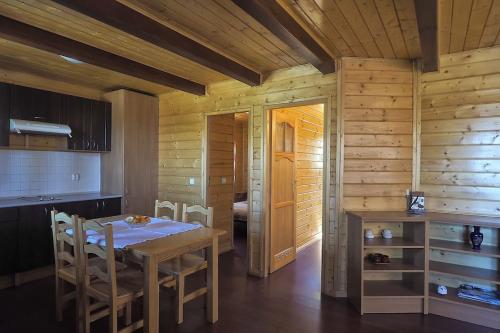 a kitchen and dining room with a table and chairs at Cozy House with Private Pool (Lago) in Arenas