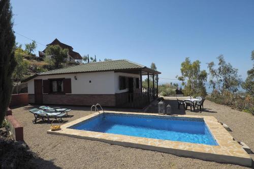 a swimming pool in front of a house at Cozy House with Private Pool (Lago) in Arenas