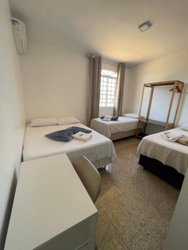 a hospital room with two beds and a window at Pousada Vitória da Vila in Brasília