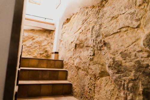 a stone wall next to a staircase in a building at Garibaldi Home in Frosinone