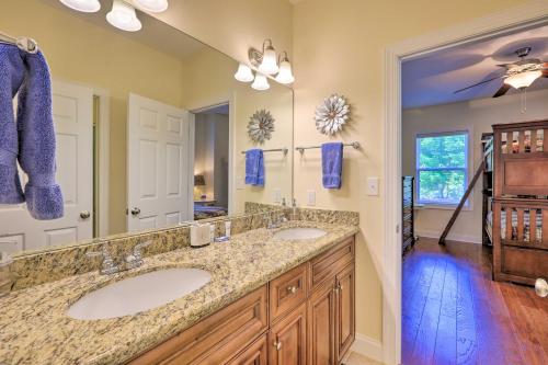 a bathroom with two sinks and a large mirror at Sunset Cove Condo Access to Lake Sinclair in Sparta