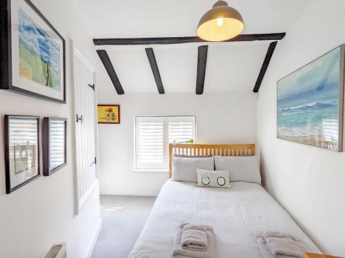 a bedroom with a bed in a room with white walls at Baytree Cottage, Walberton in Walberton