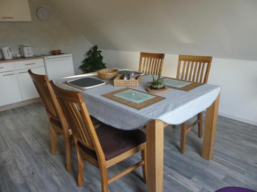 a kitchen with a table with chairs and a tableablish at Bramwaldblick in Hannoversch Münden