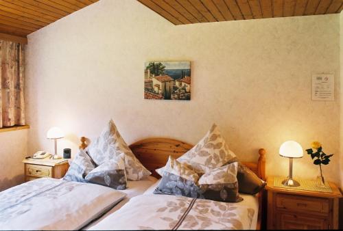 ein Schlafzimmer mit 2 Betten und einem Bild an der Wand in der Unterkunft Pension Hilberath in Kottenborn