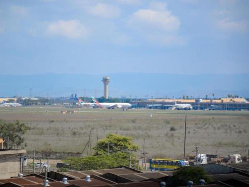 an airport with a plane on the tarmac at Pazoori Furnished Studios and 1 bedrooms in Nairobi