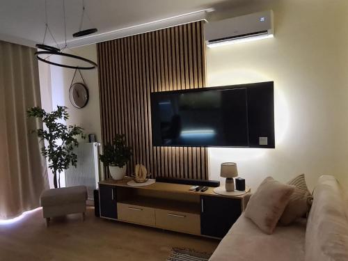 een woonkamer met een bank en een flatscreen-tv bij Malta Premium Apartment, free parking, self check-in 24h in Poznań