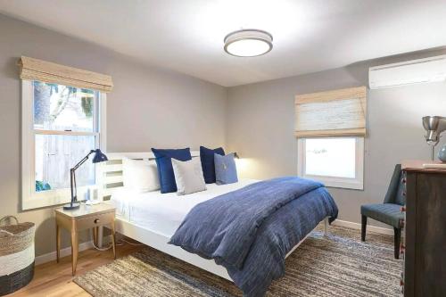 a bedroom with a large bed with blue pillows at Vine and View Cottage in Newberg