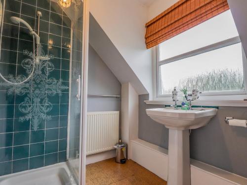 a bathroom with a sink and a shower at Hilltop House in Staffin
