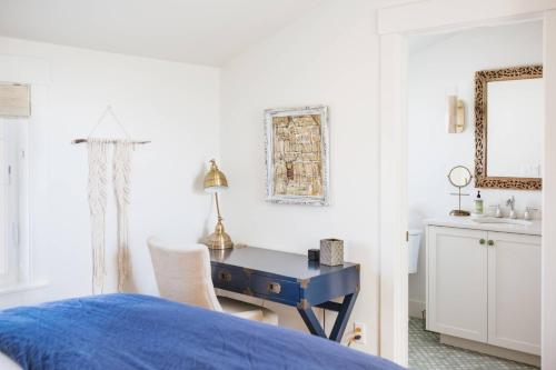 a bedroom with a blue desk and a chair at Vine and View Bungalow in Newberg