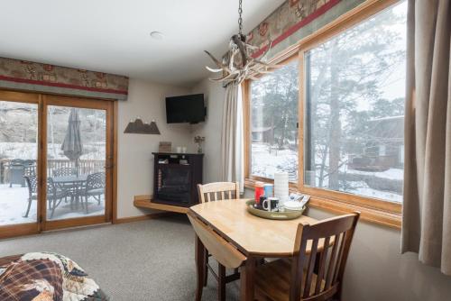 a dining room with a table and a window at Ponderosa Lodge in Estes Park