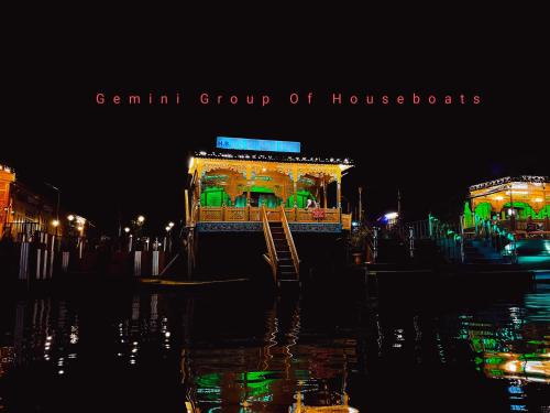 a german group of houseboats lit up at night at The Heritage Gemini Group of Houseboat in Srinagar