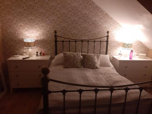 a bedroom with a large bed and two night stands at 3 bedroom, 3 story town house in Liverpool