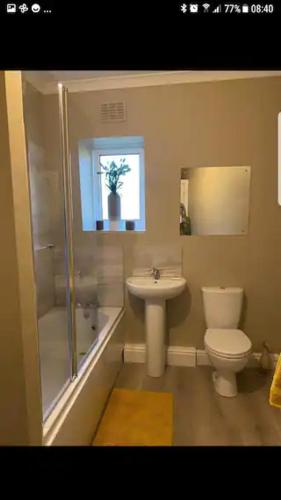 a bathroom with a shower toilet and a sink at Entire two bedroom house in penrith in Penrith