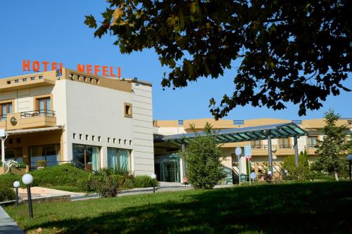 a hotel building with a sign on top of it at Nefeli Hotel in Alexandroupoli