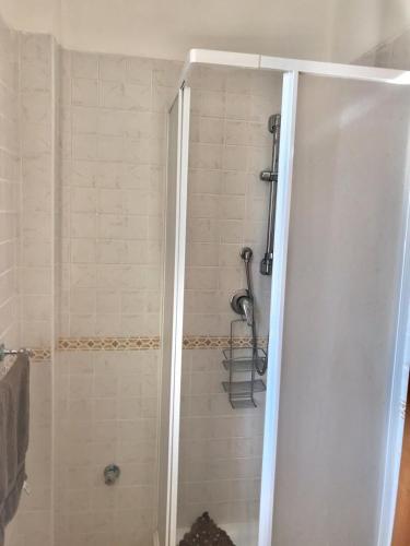 a shower with a glass door in a bathroom at San Rocco residence two bed apartments 5B2 5 in Isca sullo Ionio