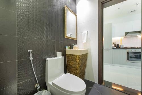 a bathroom with a toilet and a sink and a mirror at Breathtaking view compact & modern spacious studio in Dubai