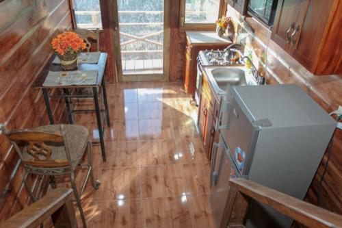 a kitchen with a stove and a sink and a table at Bella Vista Vacation in Montego Bay